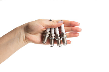 Car spark plugs in a girl's hand on a white background, isolate. Close-up