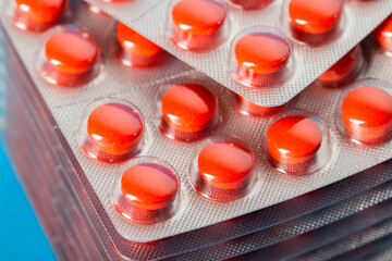 Stack of red pills, macro. Anti-inflammatory and immunomodulatory drug to improve immunity, enzymes of animal origin, lipid metabolism