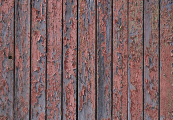 The texture of wood, wooden boards, peeling red paint on wood, background wood planks