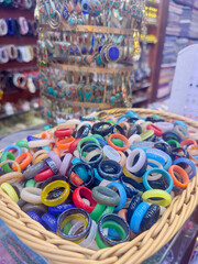 Fototapeta premium assortment of multi-colored rings made of different stones in a shop on display