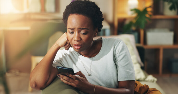 Black woman, stress and reading with phone on sofa for bad news, article or rumor at home. Female person, user or concern with mobile smartphone for app notification, alert or connection at house