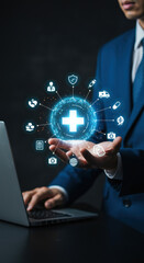 Healthcare Innovation: Man in Suit Showcasing Digital Health Solutions & Tech on Laptop for Wellness and Medical Advancements.