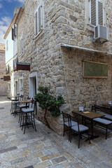 Picturesque narrow street with stone houses typical for Mediterranean countries, Budva, Montenegro