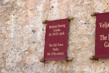Information board on facade of Old Town Walls, Budva, Montenegro