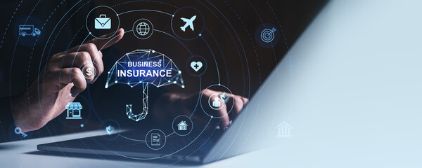 Business insurance concept with digital icons and holographic umbrella over laptop screen in futuristic blue style on dark background..