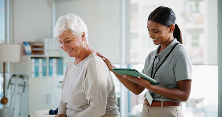 Obraz premium Consultation, senior patient and physiotherapist with tablet for rehabilitation, healthcare and recovery. Happy woman, physical therapy and medical support for healing back injury or help in clinic