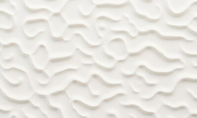 Textured white wall surface displaying subtle waves and curves.