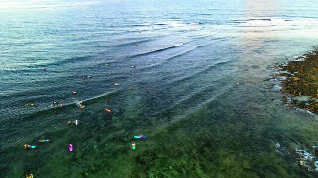Aerial: Drone Forward Shot Of People With Surfboards In Wavy Sea During Vacation - Siargao, Philippines