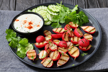 grilled radishes with cucumber slices and sauce