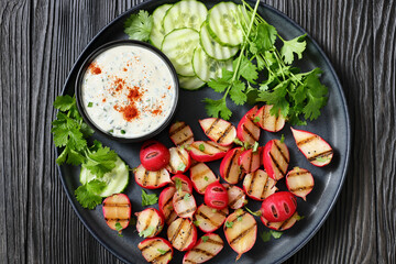 grilled radishes with cucumber slices and sauce
