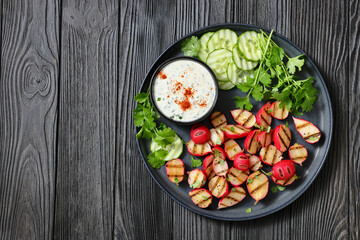 grilled radishes with cucumber slices and sauce