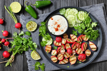 grilled radishes with cucumber slices and sauce