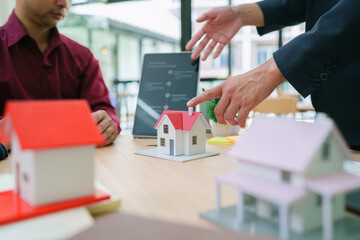 Real estate sales agent explain rental or buying condition to young couple before move to new home or apartment at real estate sales office. Asian urban lifestyle or real estate business concept.