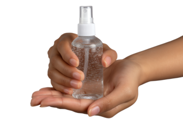 Hands holding a clear spray bottle on a white isolated background.
