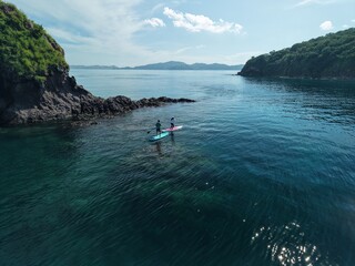 Aerial view A phinisi boat is sailing carrying tourists who will visit the islands around the waters of Labuan Bajo, East Nusa Tenggara, Indonesia.