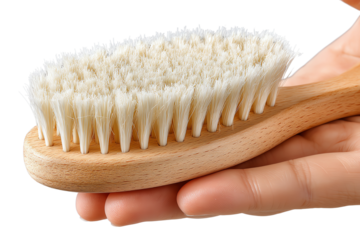 Wooden body brush held in hand, ideal for dry brushing and skin exfoliation.