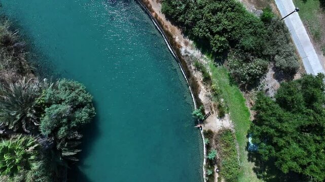 Aerial Top Downward Shot Of Blue Water Flowing In Asi River Stream On Sunny Day - Nir David, Israel