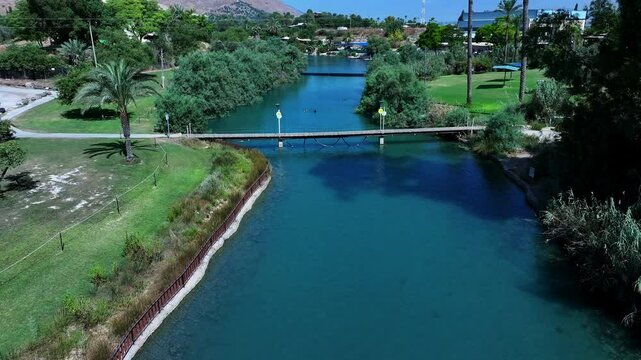 Aerial: Drone Forward Shot Of People Swimming In Asi River Water On Sunny Day - Nir David, Israel