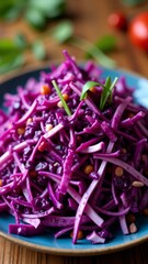 Shredded red cabbage salad on a blue plate