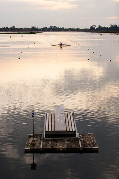 Rowers training on a lake in the evening