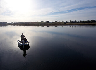 Men fishing in Boat on Lake