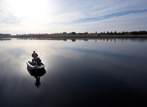 Men fishing in Boat on Lake