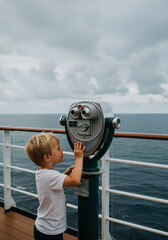 Child looking through binoculars at sea