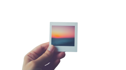 A hand holding an instant photo frame displaying an image, isolated on a transparent background. PNG