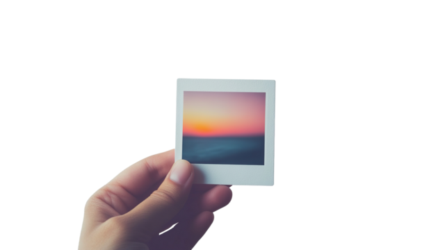 A hand holding an instant photo frame displaying an image, isolated on a transparent background. PNG