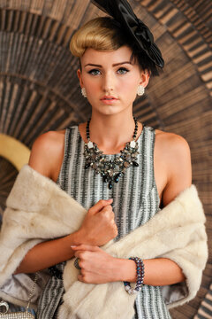 young woman with fur shawl and fancy dress hat