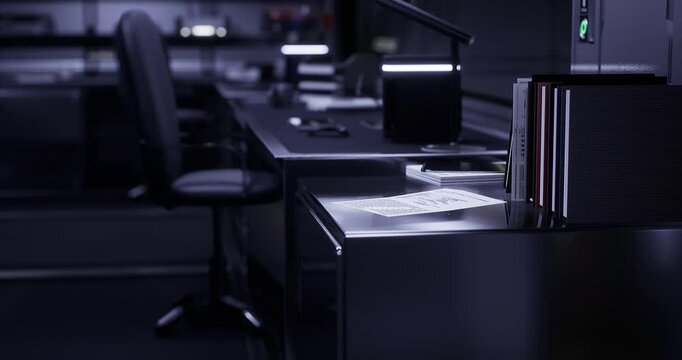 A quiet office environment illuminated by soft lighting showcases an empty desk. Papers are scattered, and a chair is pushed back, indicating recent activity.
