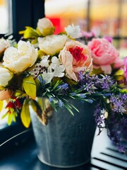 Flower arrangement in a metal bucket