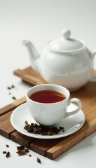 White porcelain teapot & cups, scattered tea leaves , leaves, elegant
