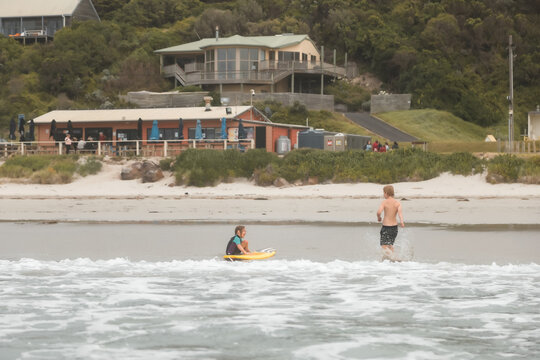 Kids in shallow water on Bridgewater Beach at Portland Victoria
