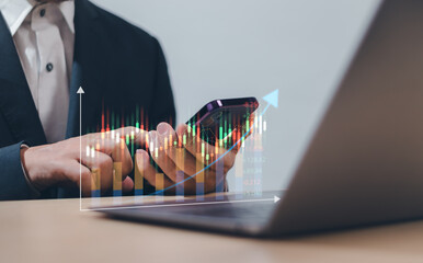 Businessman or investor using mobile phone analyze investment data with candlestick chart on virtual screen, concept of finance, dividend, gold, mutual fund, stock market, interest or digital assets
