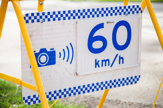 Police speed camera 60 km speed zone sign beside highway