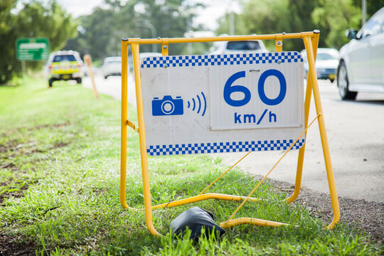 Police speed camera 60 km speed zone sign beside highway