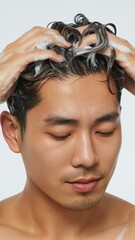 Naklejka premium Shirtless man under water stream with head tilted and eyes closed