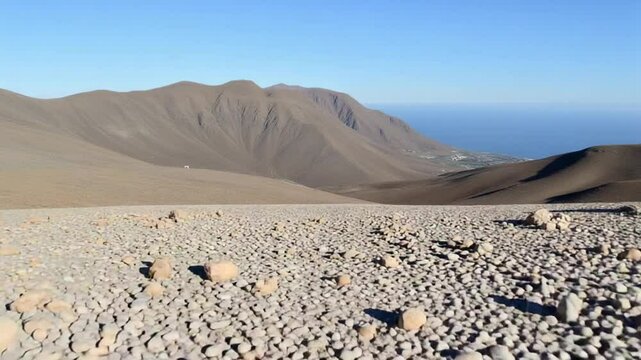 A rocky area with rocks and a mountain in the background