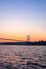 Stunning sunset over the Bridge in Istanbul, at the Asian side on a Bosphorus cruise, Türkiye 