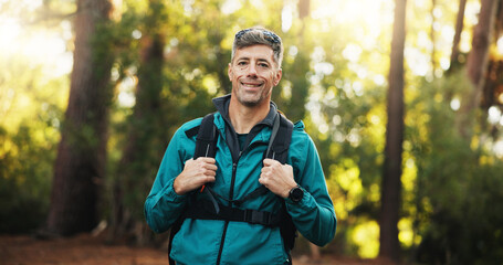Portrait, hiker and mature man with smile, journey and adventure in nature, traveller and backpacking. Hiking, travel and person on holiday in woods, trekking and exploration of environment in USA