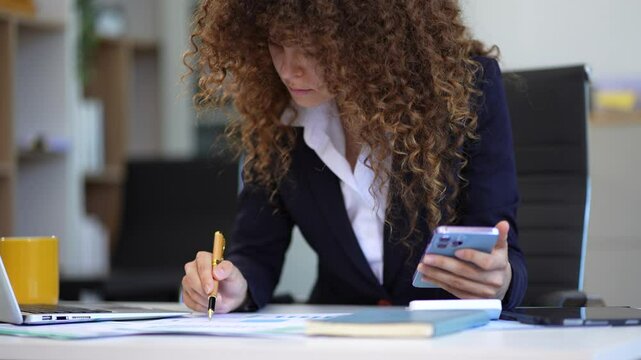 Professional businesswoman analyzing stats and graphs on paperwork outside a modern office building. Ideal for themes of success, analysis, and corporate growth.