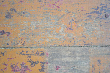 texture of the wooden surface with peeling brown and red paint