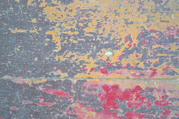 texture of the wooden surface with peeling brown and red paint