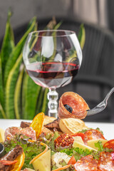 Elegant charcuterie and wine pairing with gourmet meats, cheeses, and fresh greens.