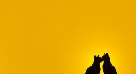 Obraz premium Silhouette of two animals kissing against a vibrant sunset.