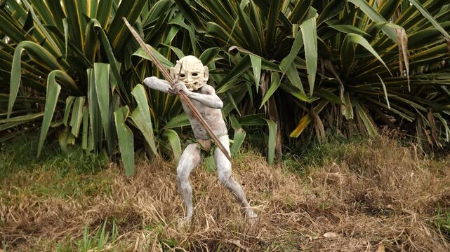 Asaro Mudmen tribe bow hunting. Papuan tribe dance. Mount Hagen tribe festival. Cultural event. Indigenous men in native costumes. High quality 4k footage