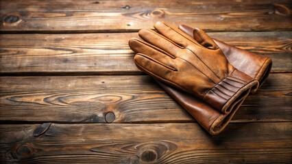 A pair of finely crafted, supple leather gloves rests on a rustic wooden surface, showcasing exquisite craftsmanship and timeless style