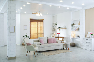 Comfortable sofa with cushions in room. Interior design