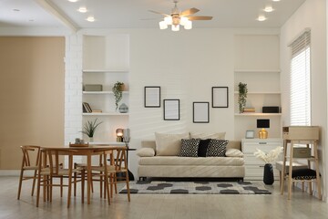 Comfortable sofa, table, chairs and dresser indoors. Interior design
